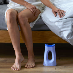An image of a woman getting up from bed that shows she has a Loona Female Urinal stored under the bed in a convenient location. An image of a woman getting up from bed that shows she has a Loona Female Urinal stored under the bed in a convenient location.
