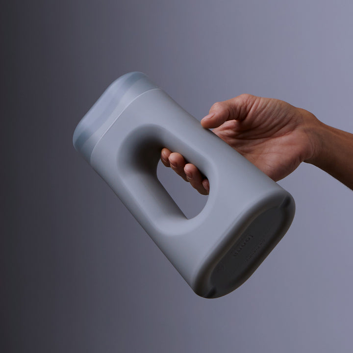 a woman's hand easily holding a handheld urinal
